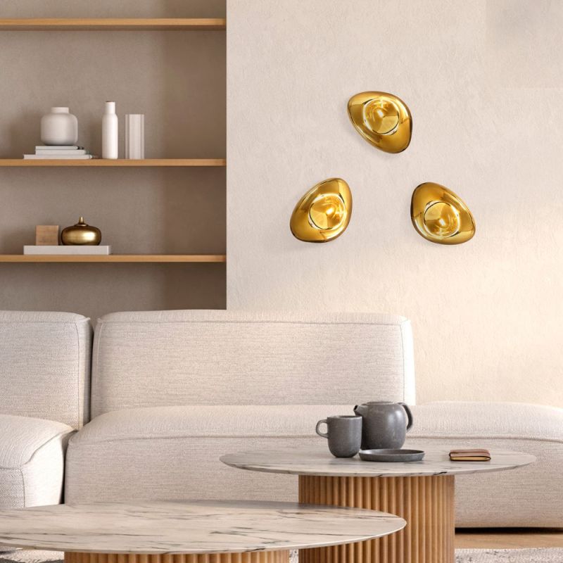 Three golden glass wall lights arranged in a group